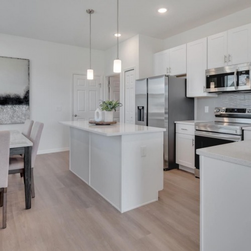 a kitchen with white cabinets