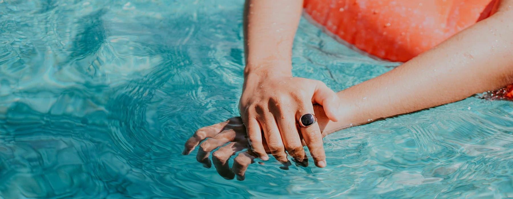 woman relaxes on a floatie in swimming pool