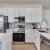 a kitchen with white cabinets